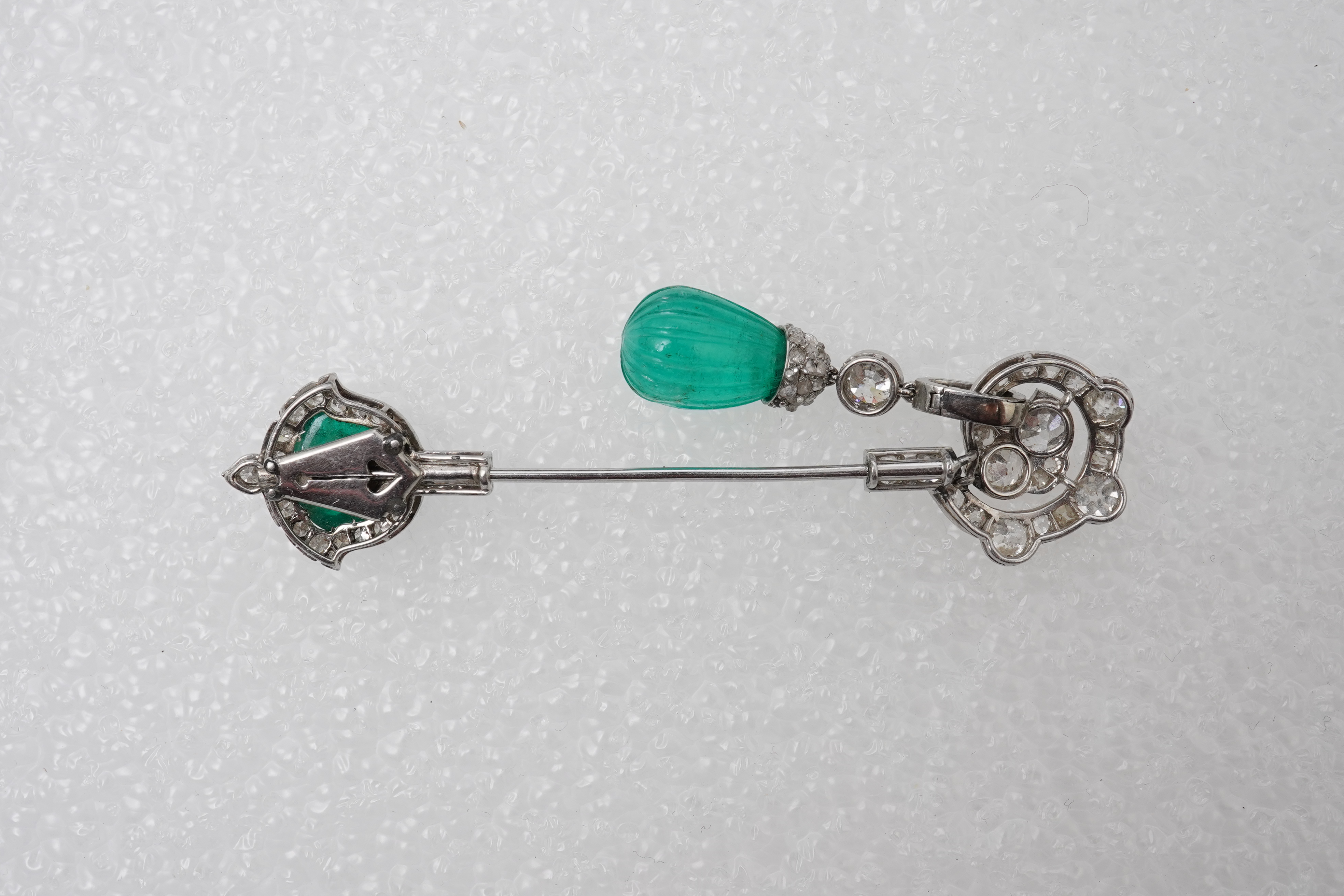 A fine Art Deco carved emerald and diamond jabot pin, circa 1925